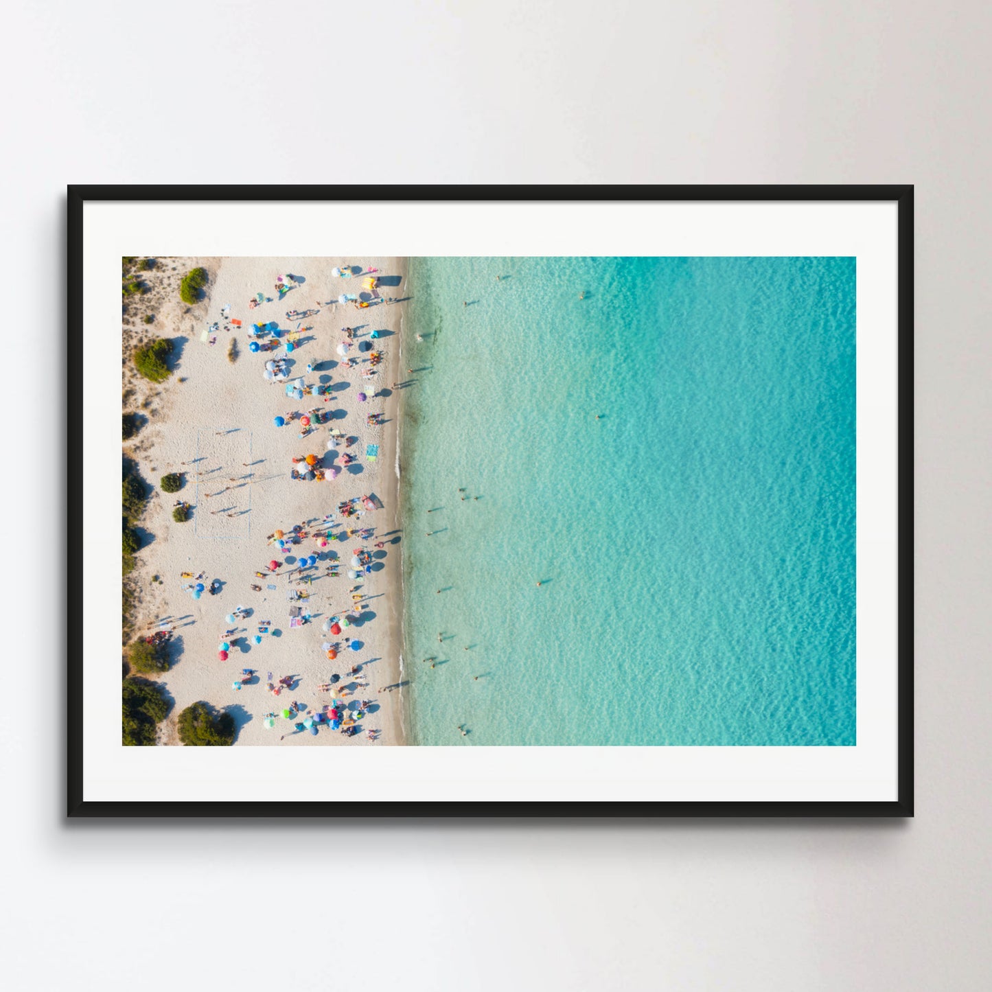 View from above, stunning aerial view of a white sand beach full of beach umbrellas and people swimming in a turquoise water. Spiaggia del Principe, Costa Smeralda, Sardinia, Italy.