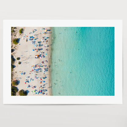 View from above, stunning aerial view of a white sand beach full of beach umbrellas and people swimming in a turquoise water. Spiaggia del Principe, Costa Smeralda, Sardinia, Italy.