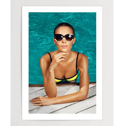 woman near the pool, wearing glasses and swimsuit, tans