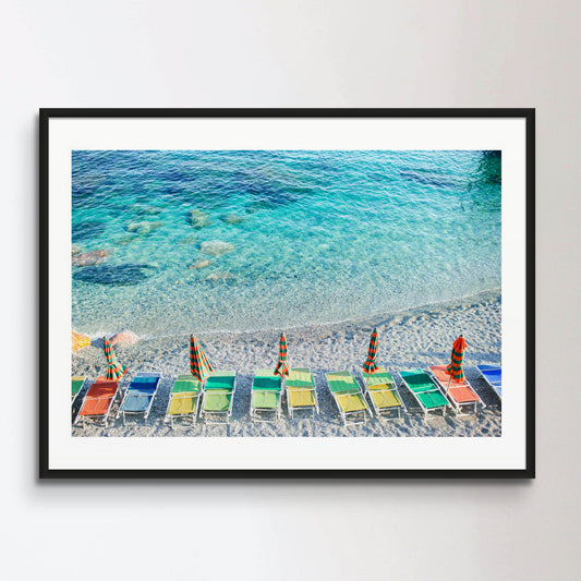 Empty beach with closed umbrellas on italian coast