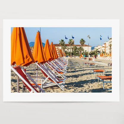 Viareggio beach with colorful umbrellas at sunset, Viareggio, Italy.