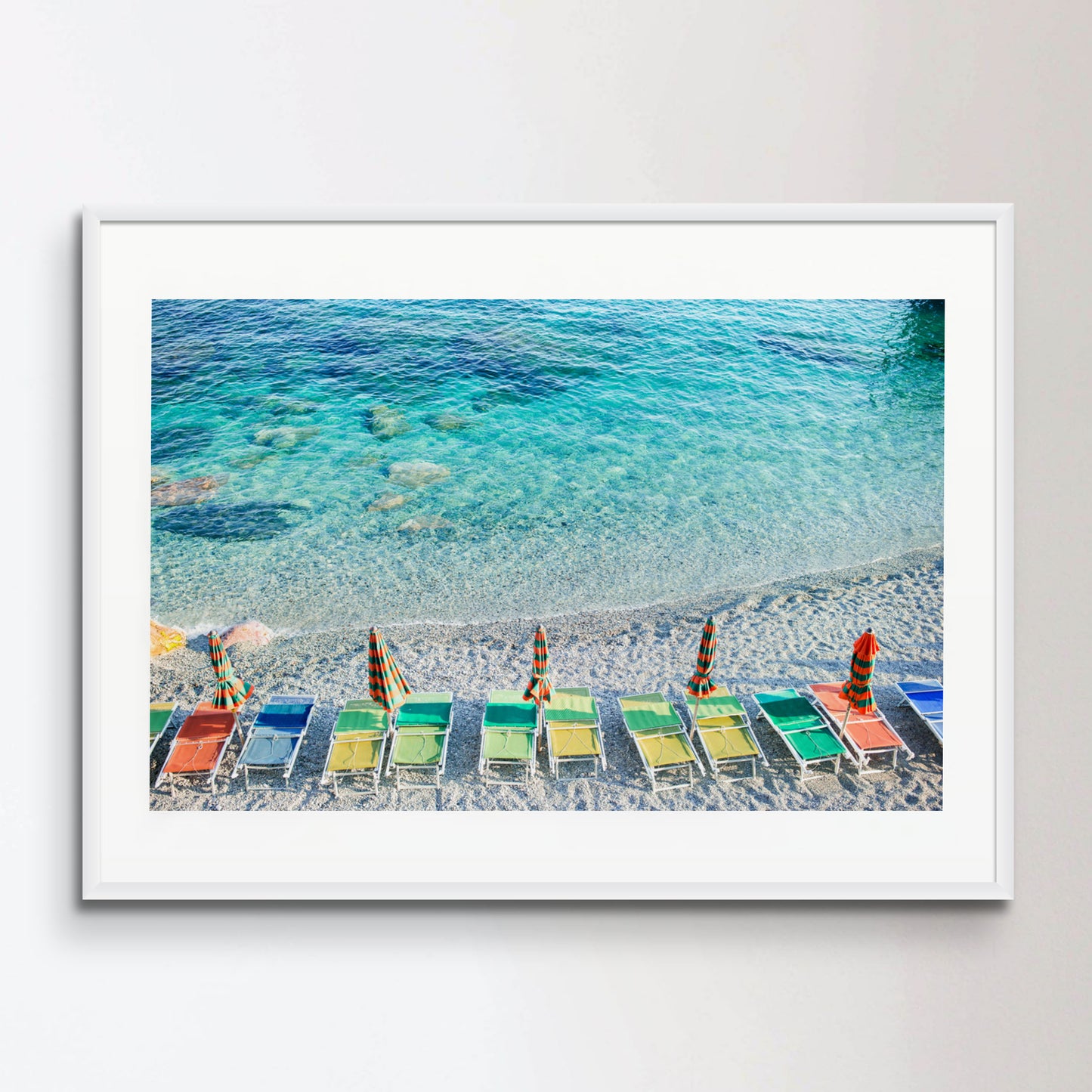 Empty beach with closed umbrellas on italian coast