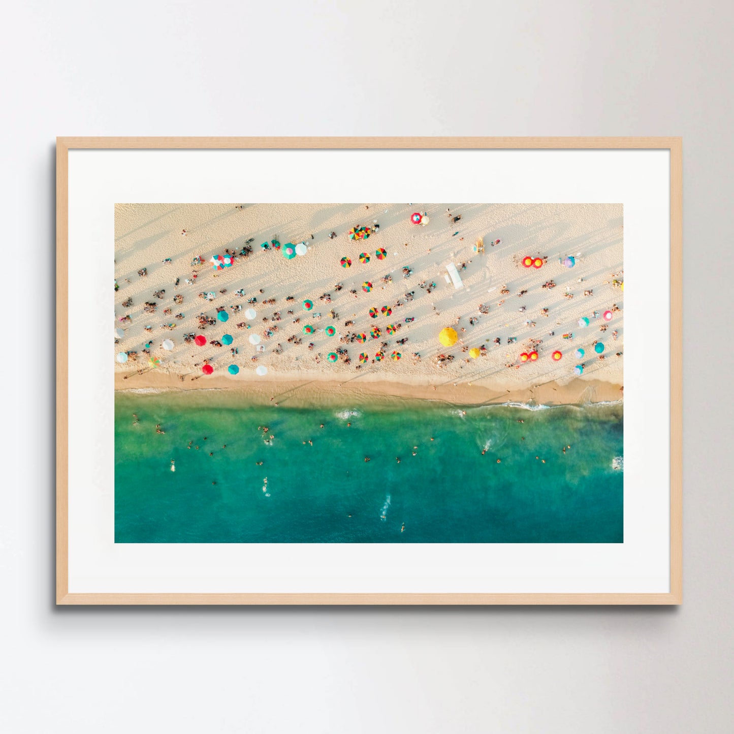 Aerial view of a crowded beach, umbrellas and people on the sand