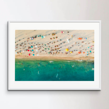 Aerial view of a crowded beach, umbrellas and people on the sand